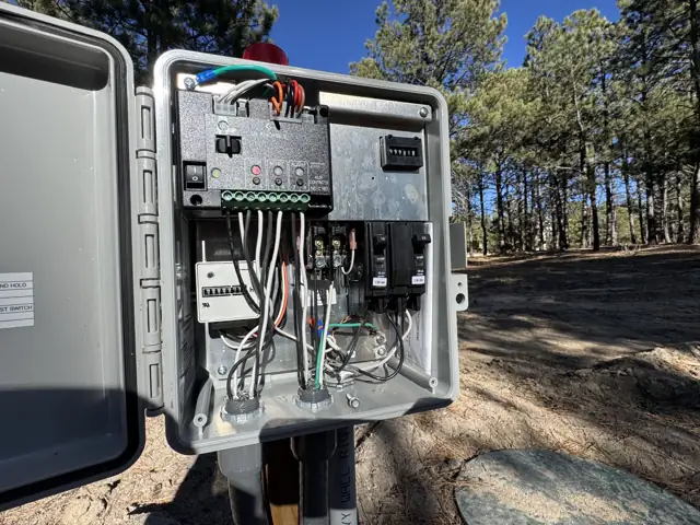 Septic system control panel with the door open showing the wiring