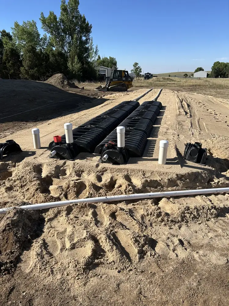 Rows of drain field chambers laid out in a graded trench area